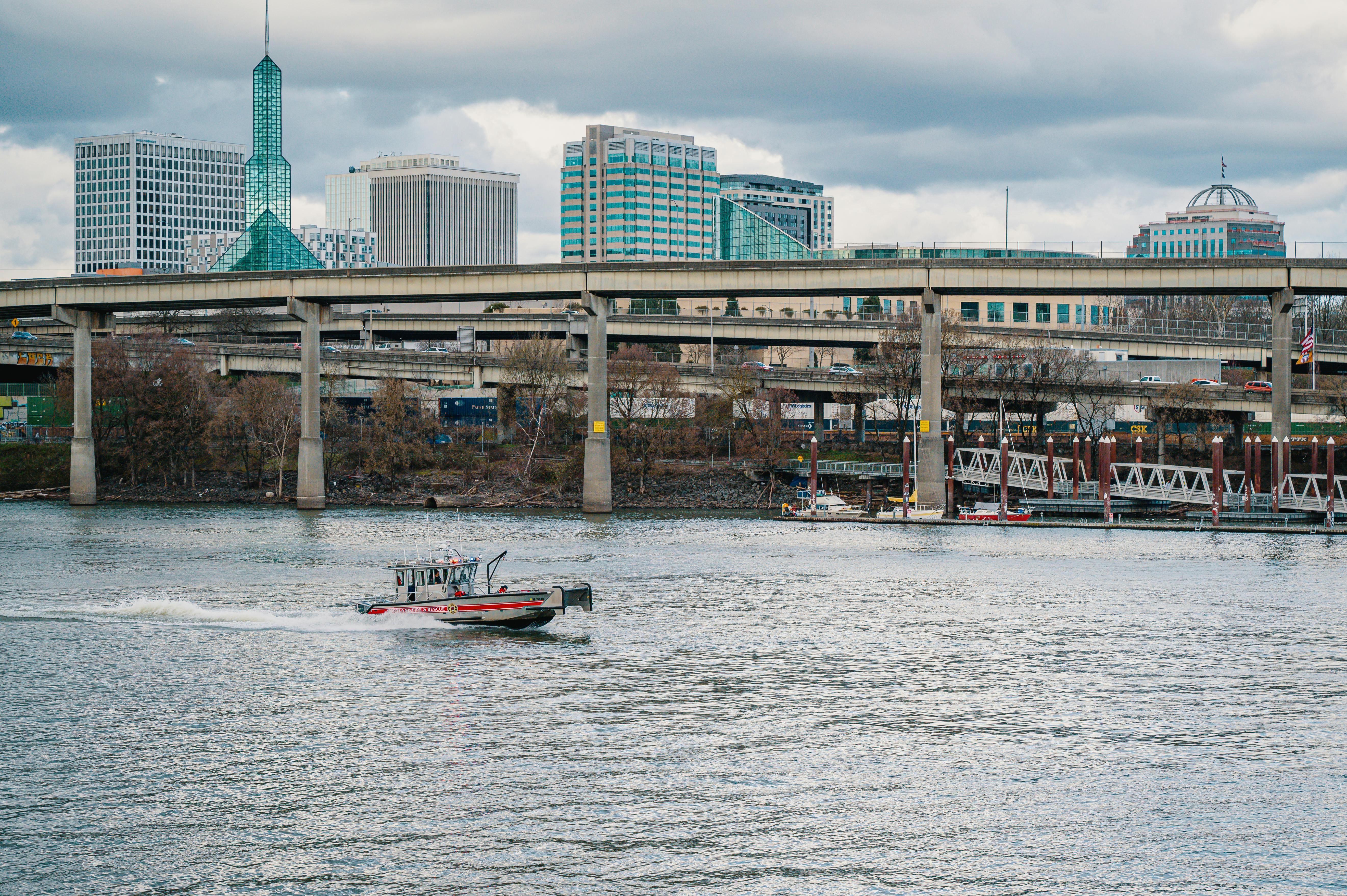 a boat on a river with the view of the city of portland oregon