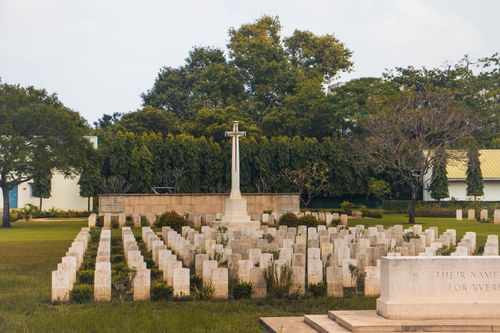 Free Peaceful military cemetery with rows of tombstones and a central cross monument. Stock Photo