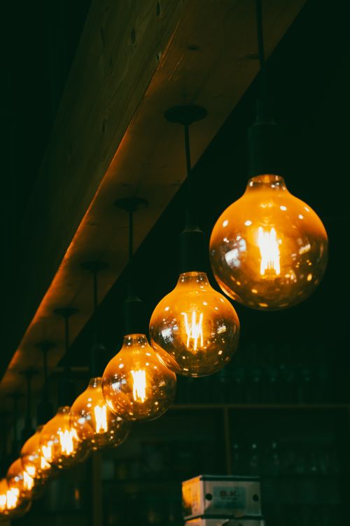 Free Decorative hanging light bulbs casting a warm and cozy ambiance in an interior setting. Stock Photo