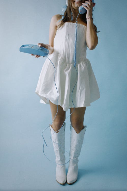 Woman Wearing White Dress Holding a Telephone 