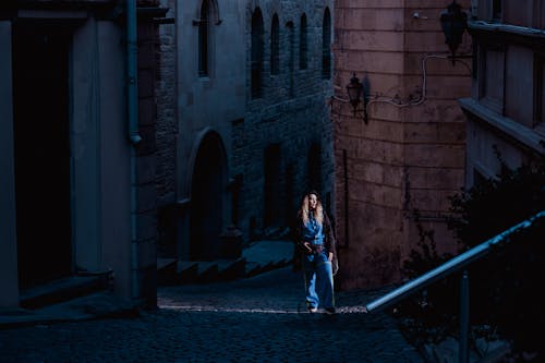 Woman Standing in an Empty Alley
