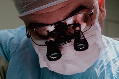 Male Surgeon Wearing Surgical Loupes