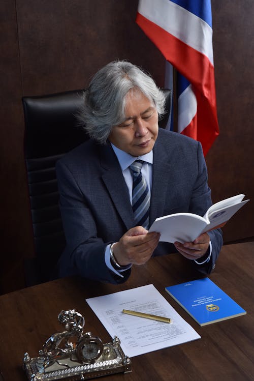 Man in Suit Reading Documents