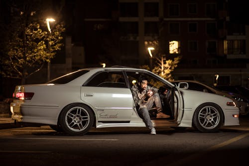 Free A man sitting in the driver's seat of a car Stock Photo