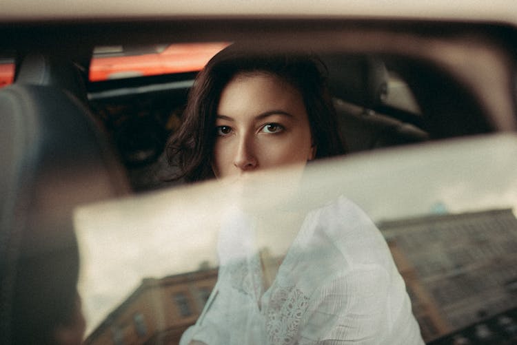 Brunette Woman Sitting In Car