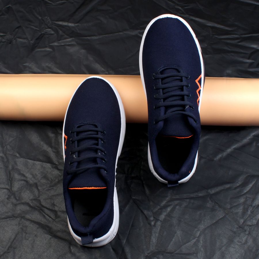 Navy blue sneakers on dark textured background