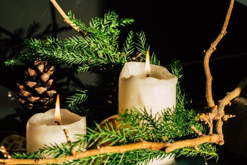Close-up of a Christmas Decoration with Candles and Conifer Twigs
