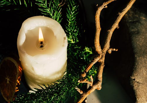 Close-up of a Christmas Decoration with a Candle and Conifer Twigs