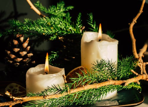 Close-up of a Christmas Decoration with Candles and Conifer Twigs