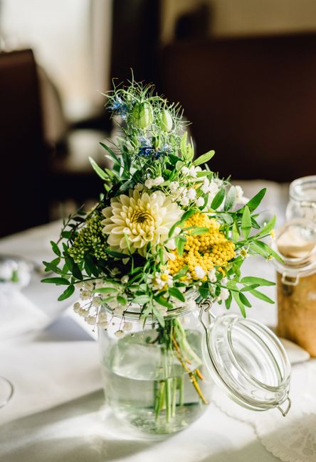 Charming rustic bouquet of flowers in a glass jar adds a natural touch to decor.