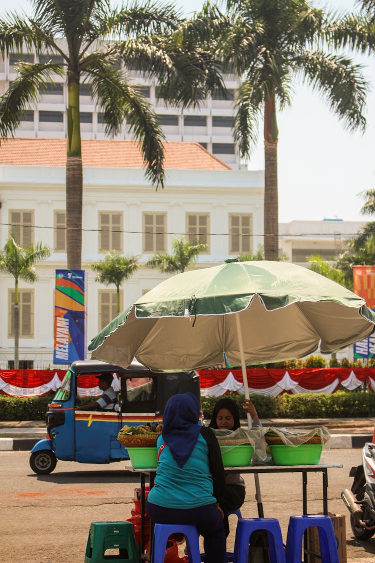 People Trading Goods At A Street Market Stand