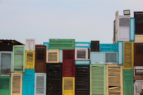 Building Made of Colorful Doors and Shutters with Louvres