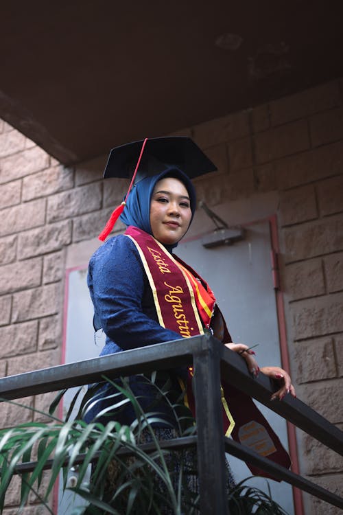 Student in Mortarboard by the Railing