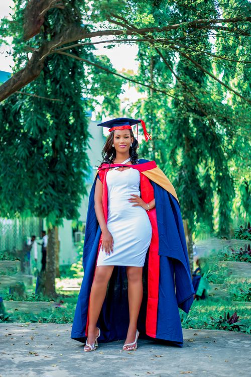 Free Woman in graduation attire posing outdoors, blending academia with elegance. Stock Photo