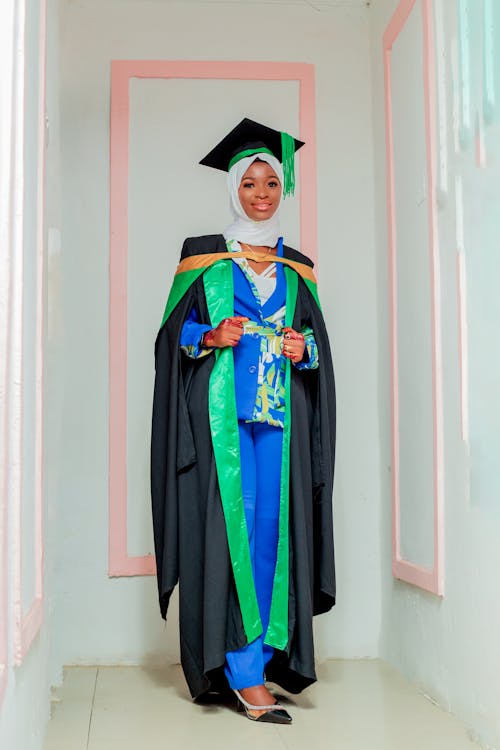 Student in Graduation Gown over Blue Blazer and Trousers