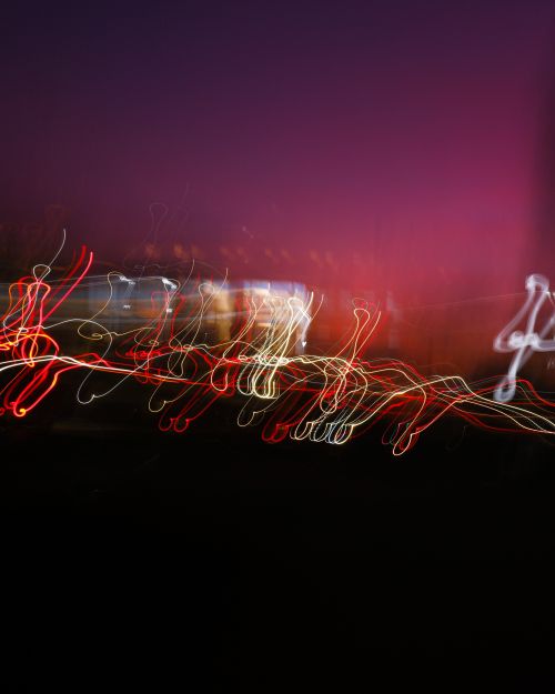 Free Abstract long exposure photo showing colorful, dynamic light trails against a dark backdrop. Stock Photo
