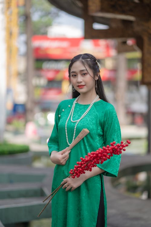 Brunette in Emerald Dress and Pearl Necklace