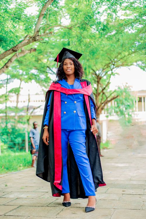 L Graduation Woman in a Graduation Gown and Cap · Free Stock Photo