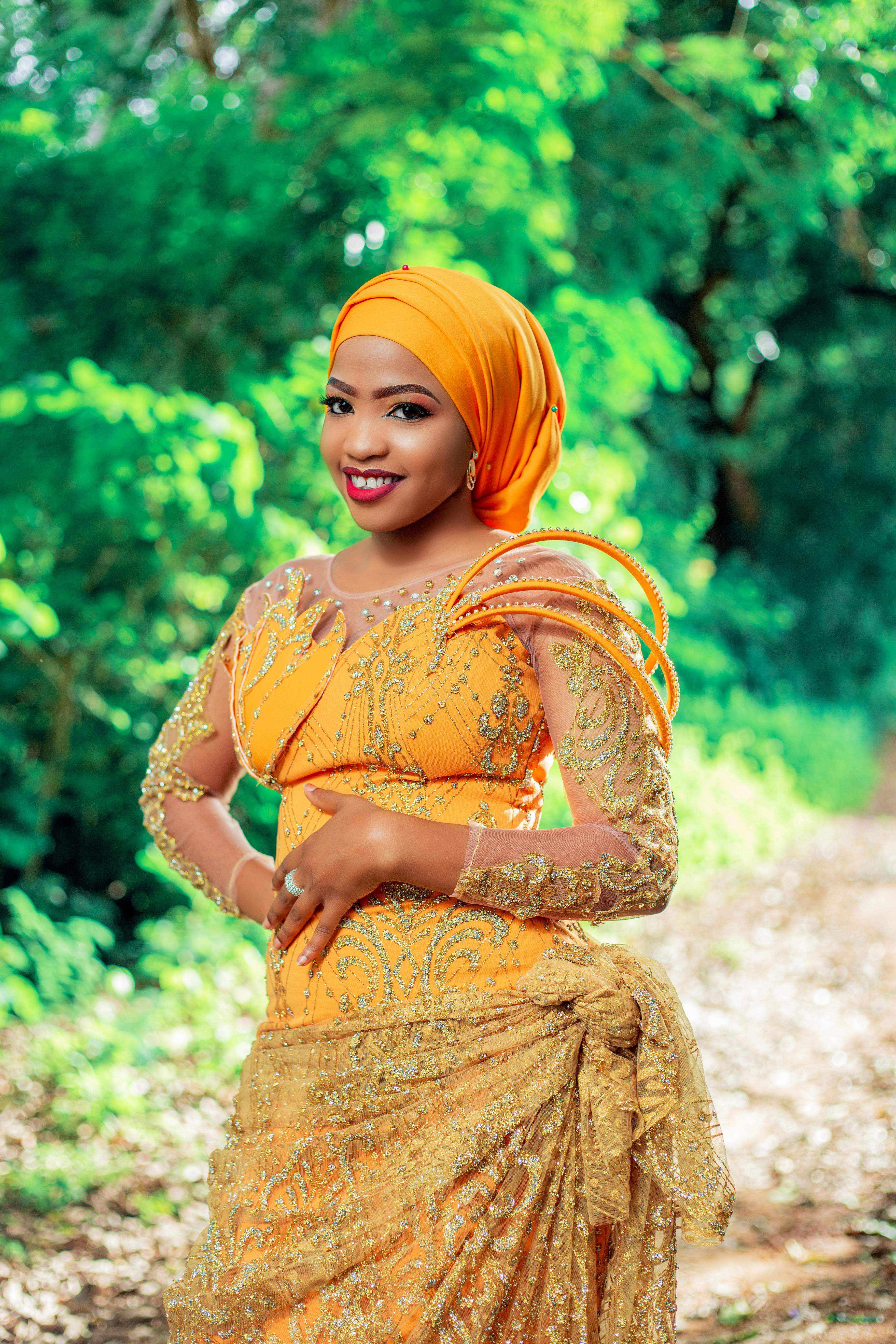 Young Woman Posing in Embroidered Orange Dress and Headscarf · Free