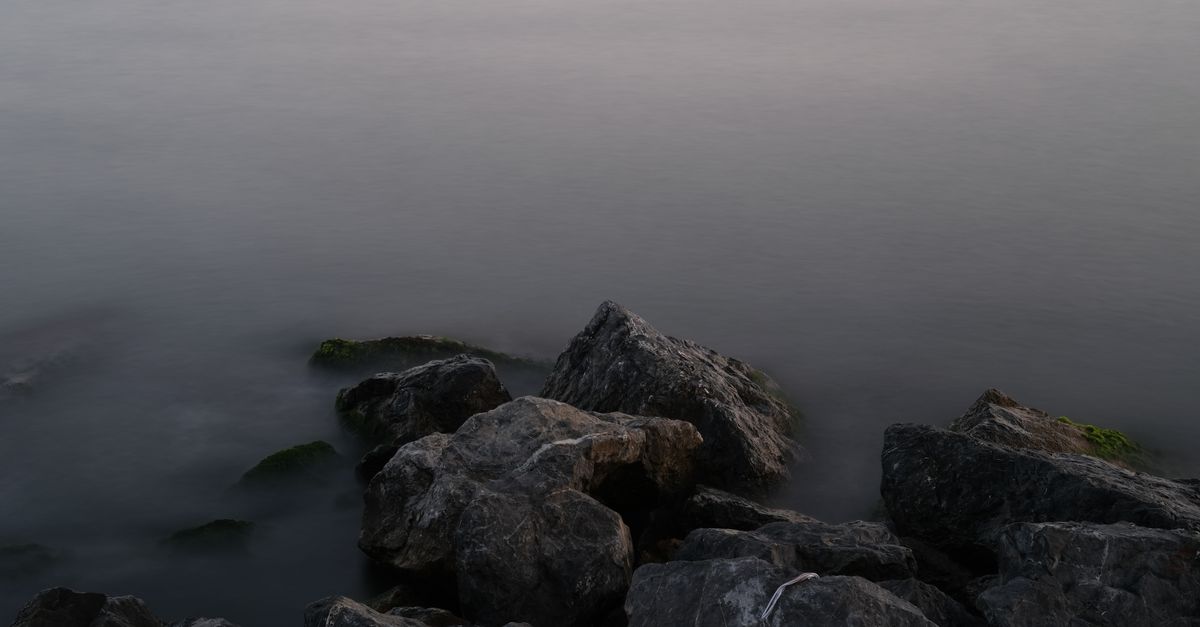 Fog over Water and the Rocks on the Shore · Free Stock Photo