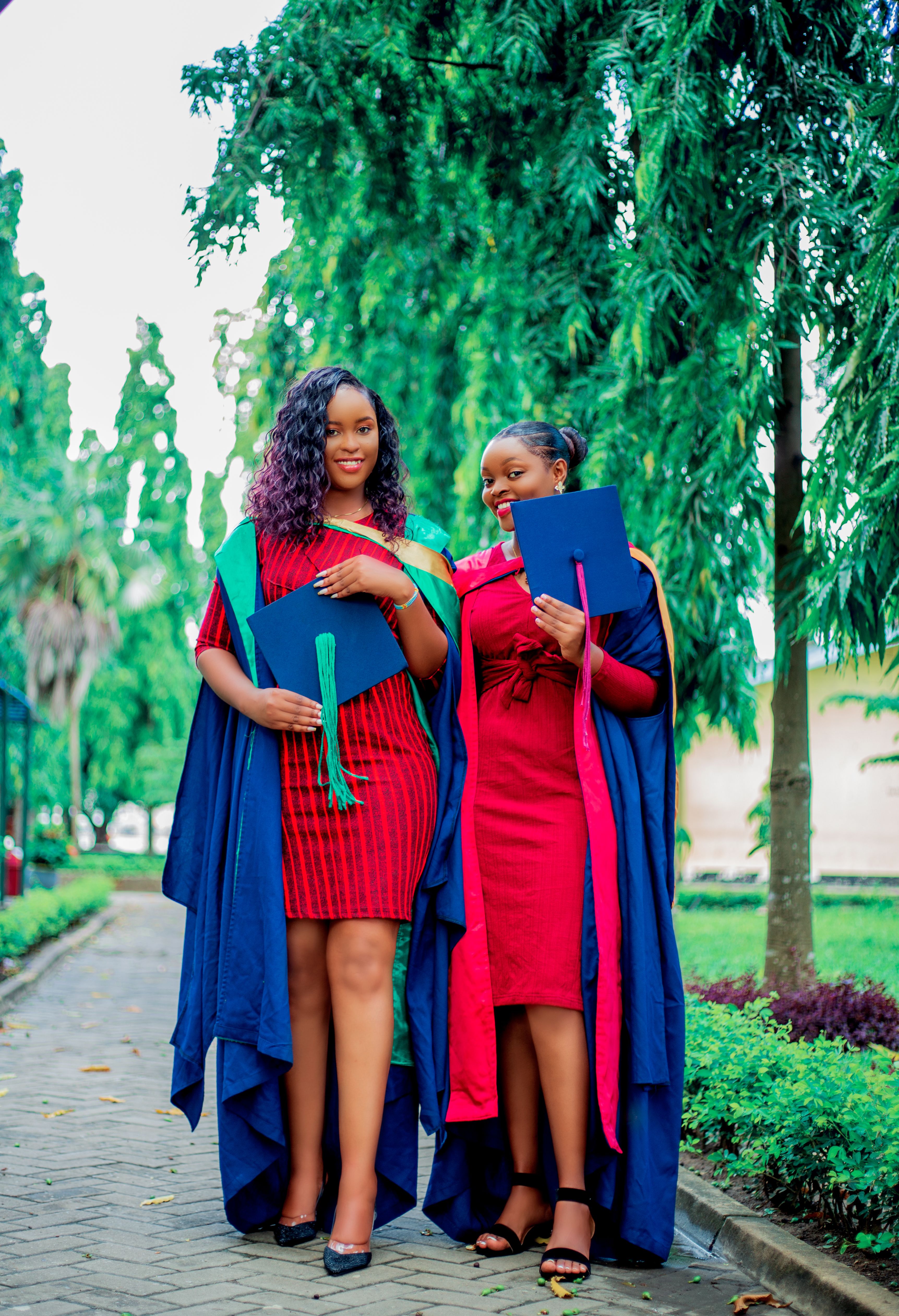 Smiling Graduates Posing with their Hats · Free Stock Photo