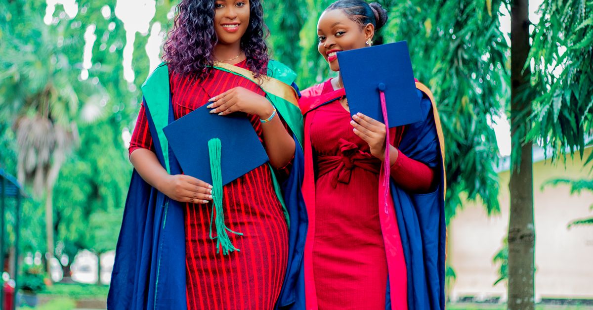 Hashtag Graduated Smiling Graduates Posing with their Hats · Free Stock Photo