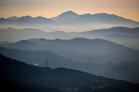 Breathtaking view of a misty mountain range at dawn. Perfect for scenic wallpapers.