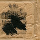 Black ink brushed across kraft paper, by Heather Green on Pexels