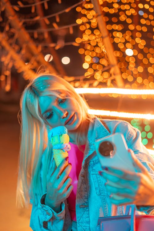 Young Blonde Woman in Denim Jacket Taking a Selfie
