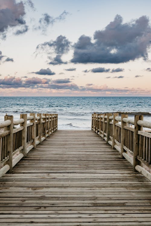 View of the Sea at Sunset from a Wooden Pier 
