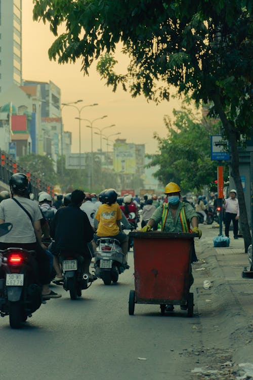 Traffic Street with Motor Scooters and Garbage Man