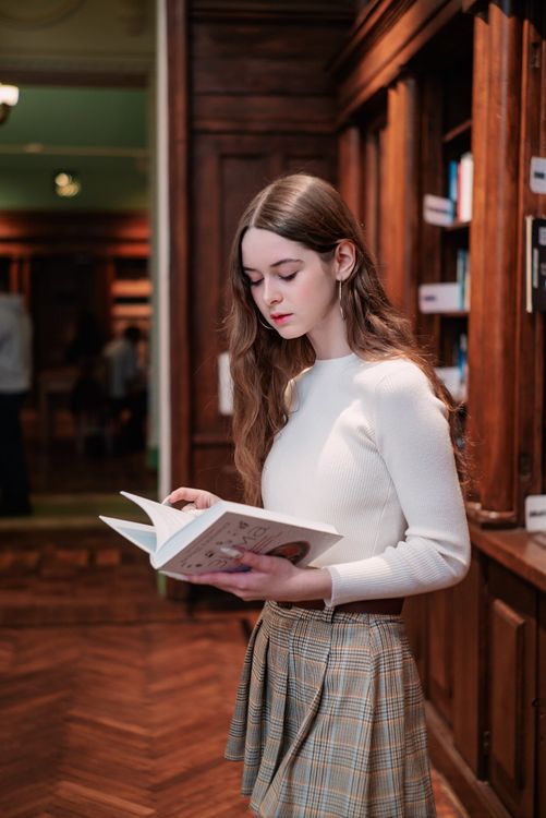 Young Model with Book in Library · Free Stock Photo