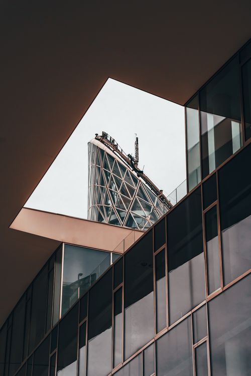 Free Unique view of Milan's modern architecture through a geometric opening, showcasing sleek glass facades. Stock Photo
