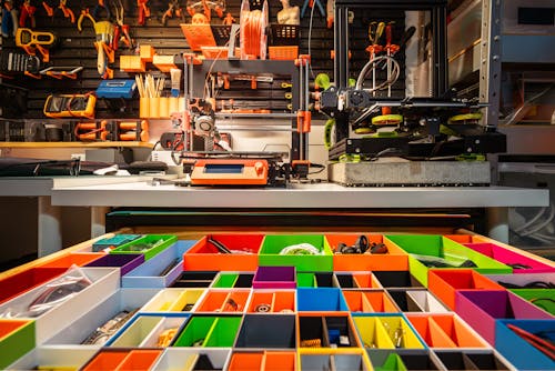 View of a 3D Printer and Tools in a Workshop 