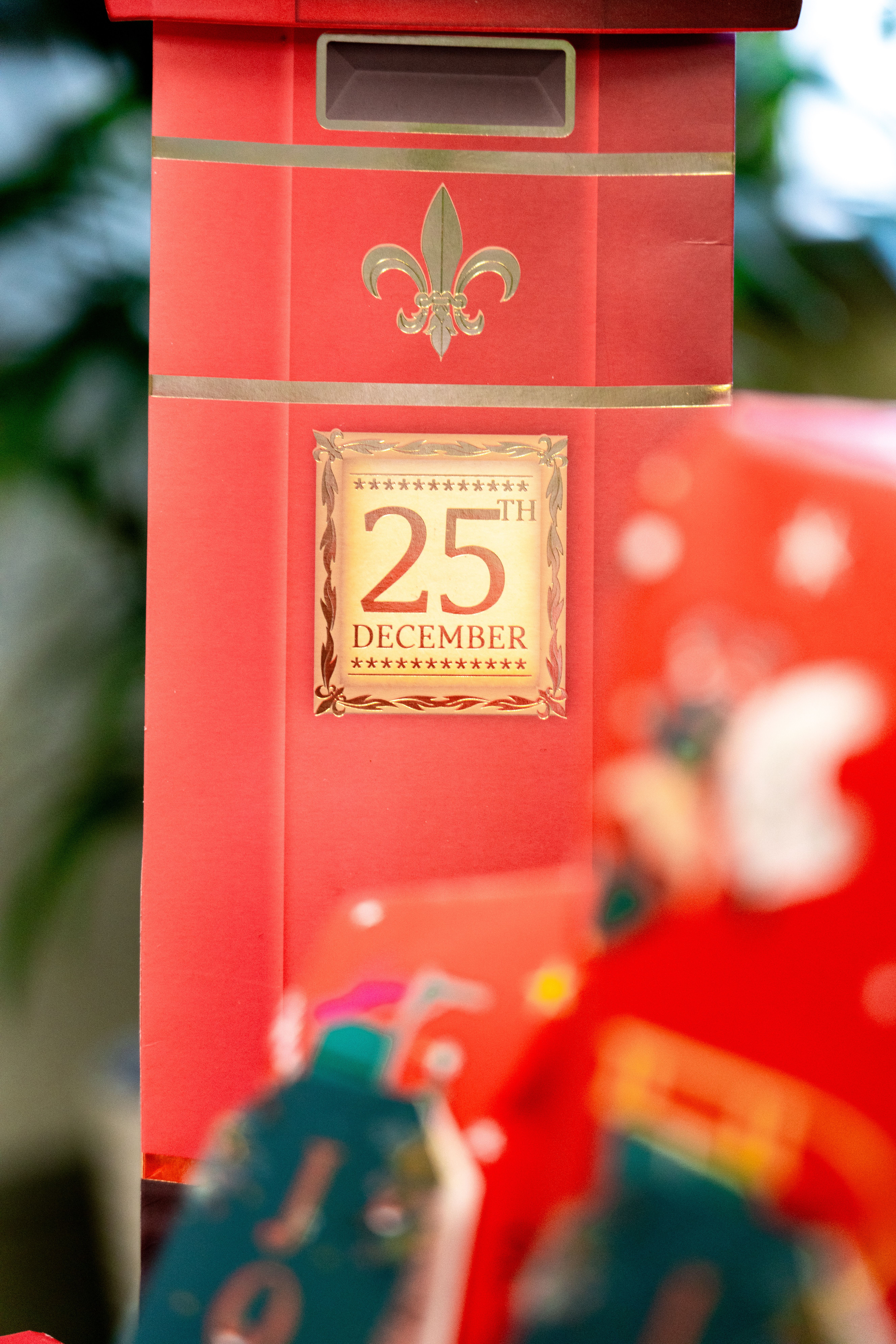 Red mailbox-themed decoration with '25th December' sign symbolizing Christmas celebration.