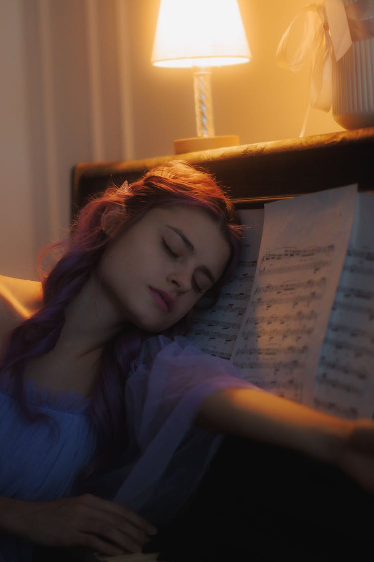 Young Woman Sleeping On Piano