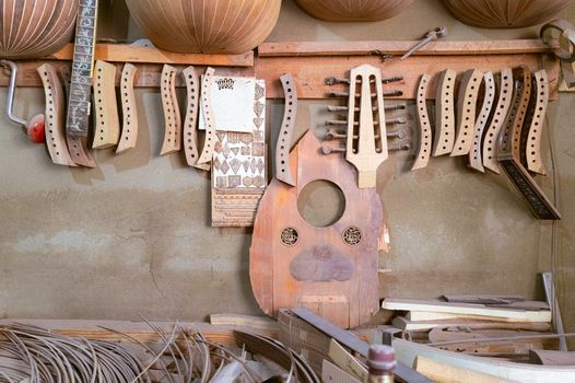 Handcrafted musical instrument parts and tools in a luthier's workshop.