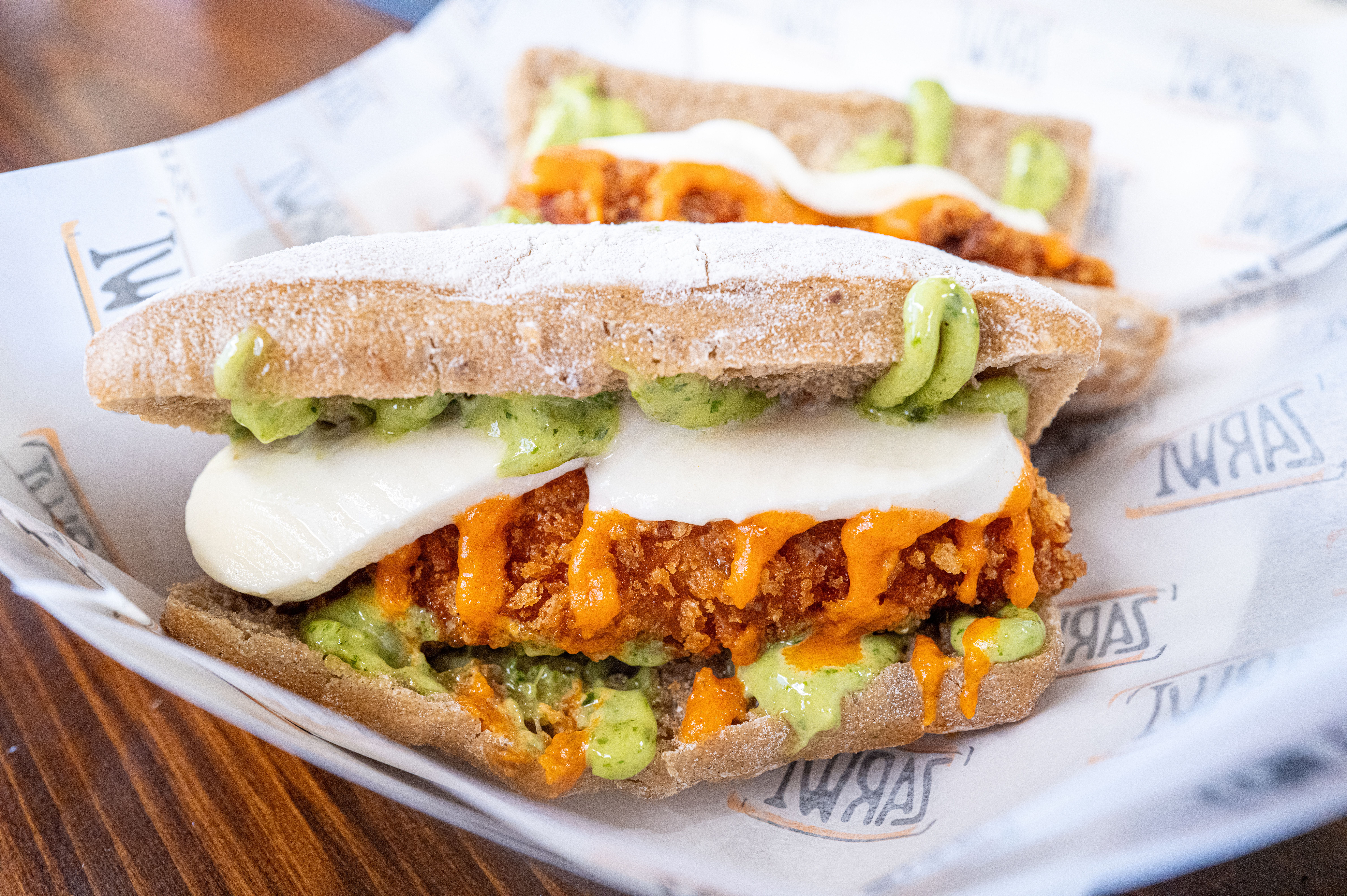 Chicken avocado sandwich with fresh greens at Karomi Cafe