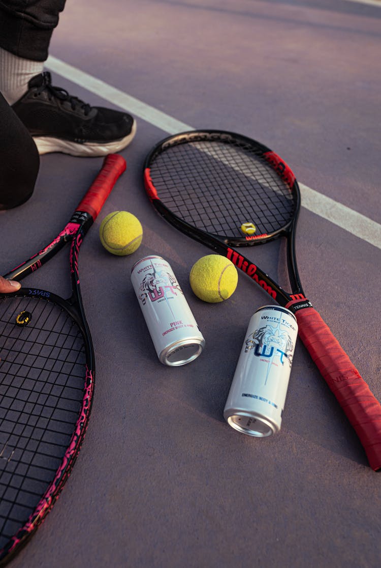 Energy Drinks, Tennis Balls And Racquet And Court