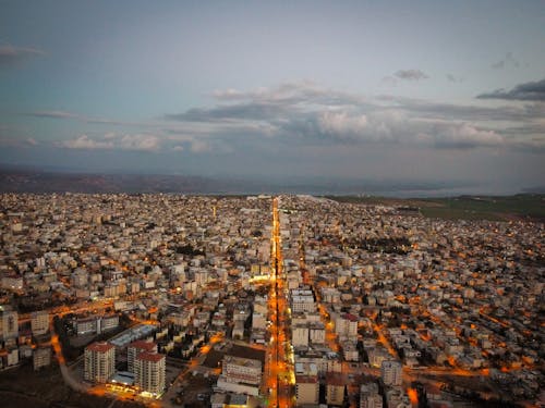 Aerial View of a Dense City with Illuminated Streets 