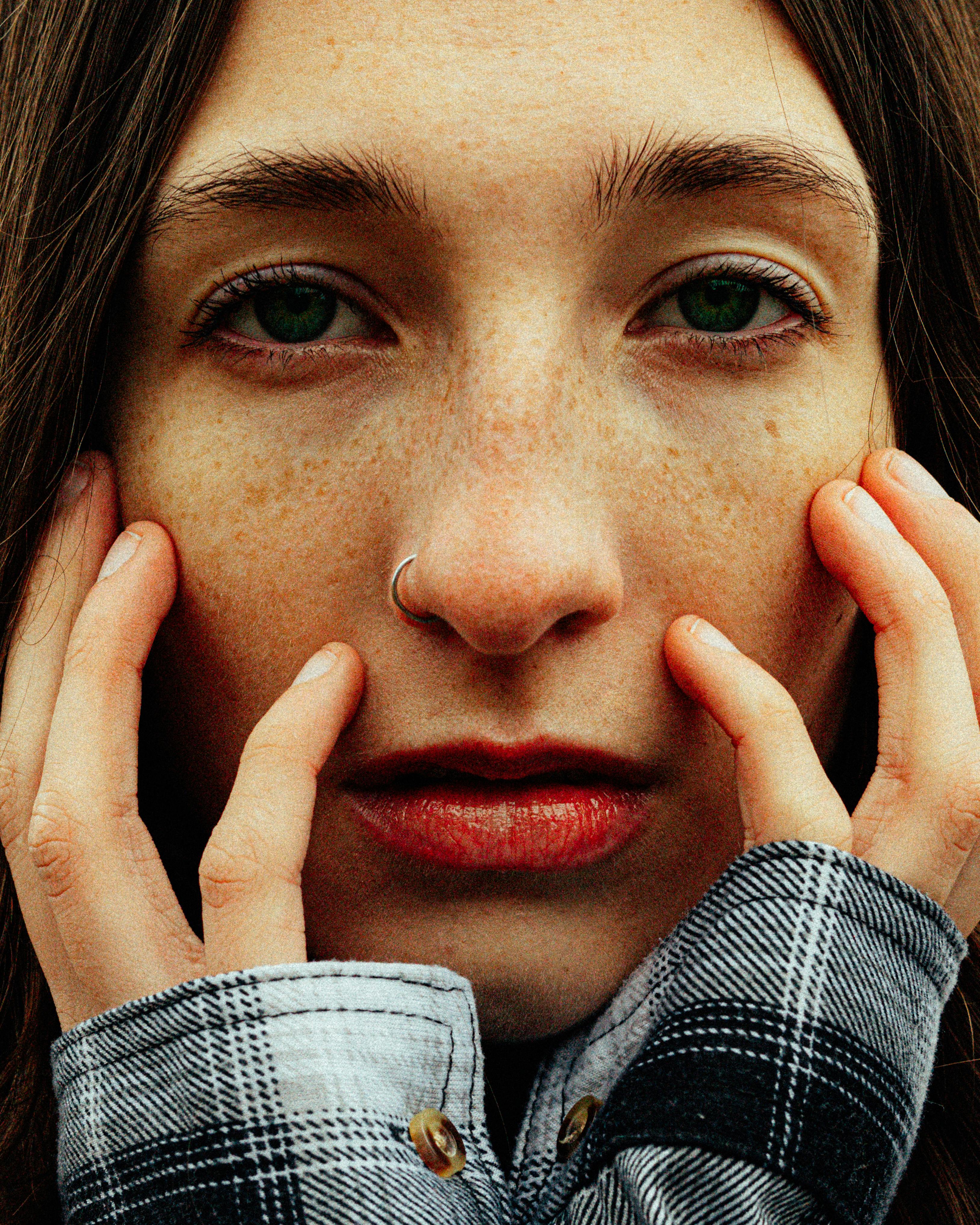 cinematic shot of a woman with green eyes and freckles