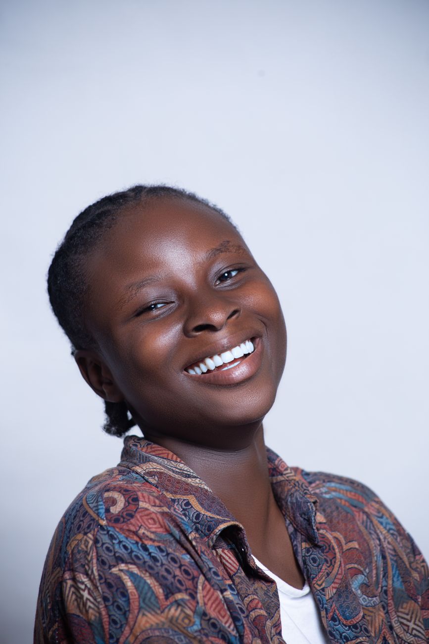 Cheerful studio portrait of a smiling woman exuding happiness and confidence.