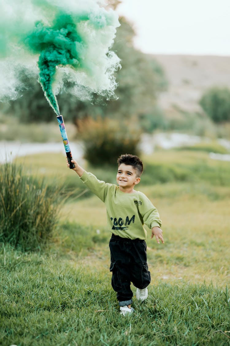 Little Boy Holding A Flare 