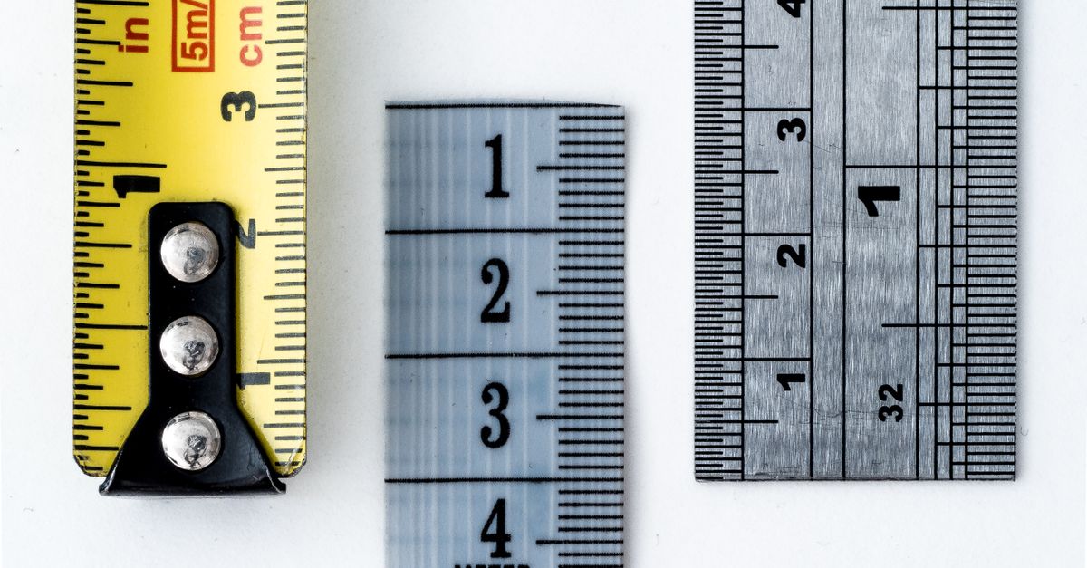 A measuring tape and ruler placed side by side representing feature comparison for SEO tools similar to Ahrefs