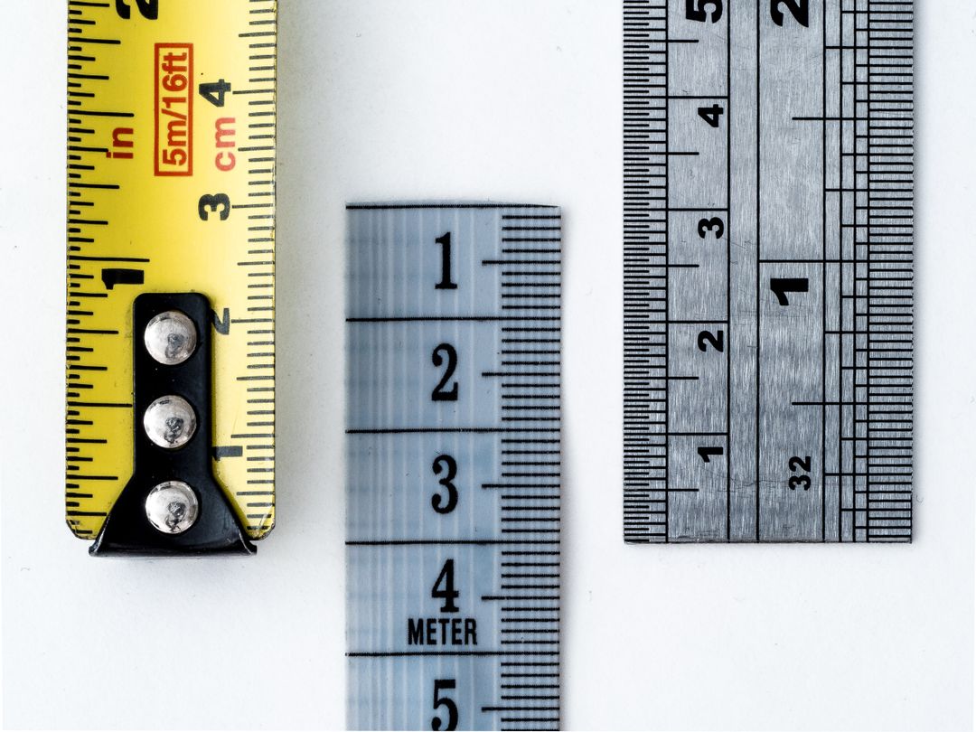 High-resolution image of a tape measure and rulers, showing precise millimeter, centimeter, and inch markings.