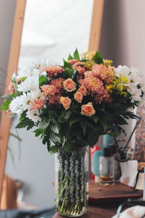 Free Beautiful bouquet of mixed flowers in a decorative vase, ideal for home decor. Stock Photo
