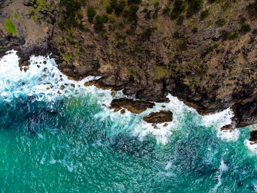 Drone Shot of Waves Crashing on a Rocky Shore 