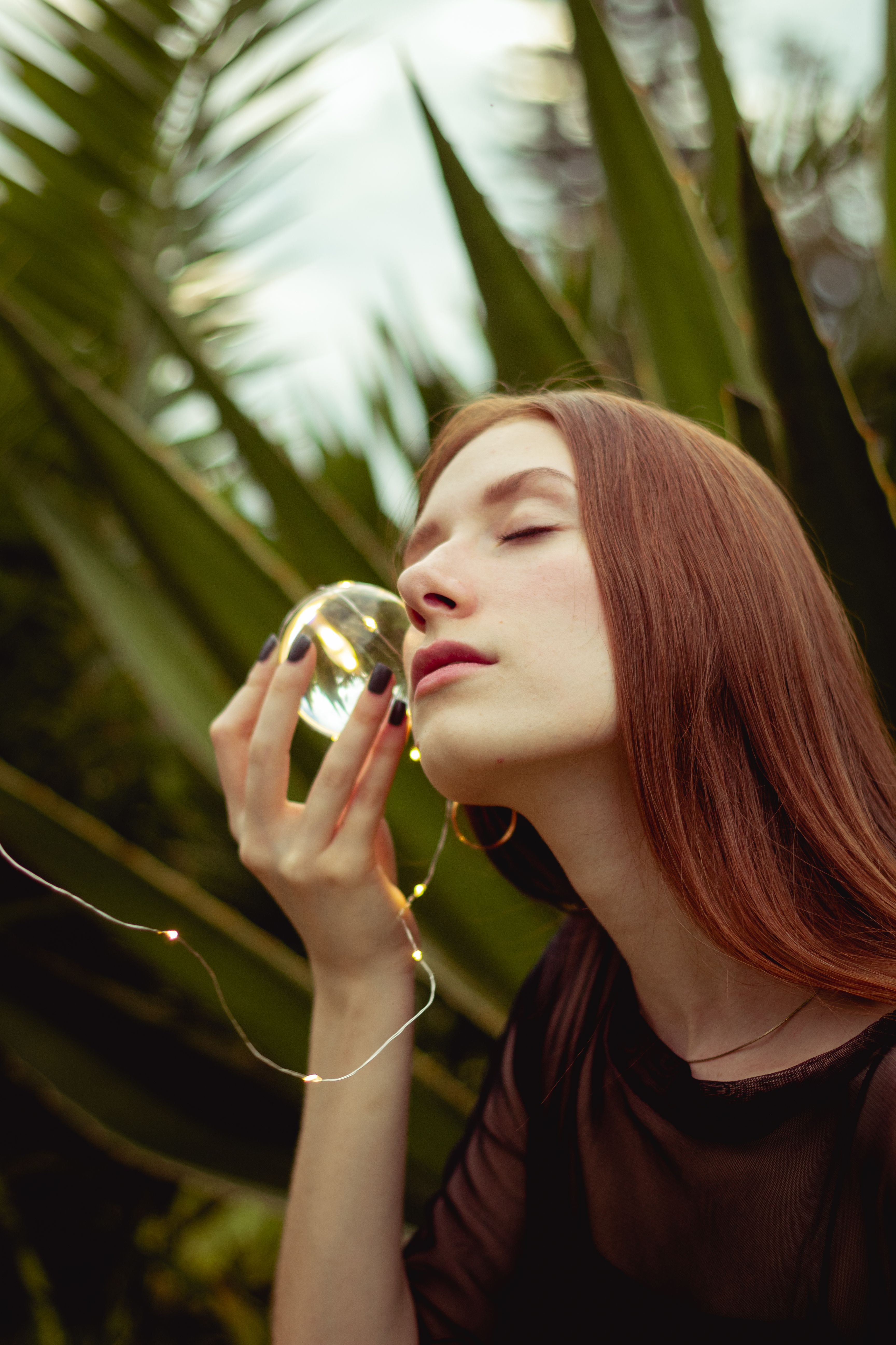 Serene Young Woman with Crystal Ball Outdoors · Free Stock Photo