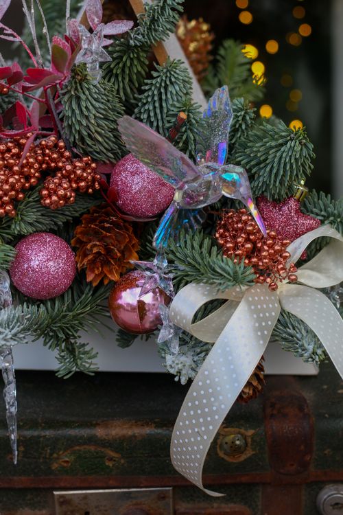 Free Vibrant Christmas decoration with ornaments on evergreen branches, ideal for festive themes. Stock Photo