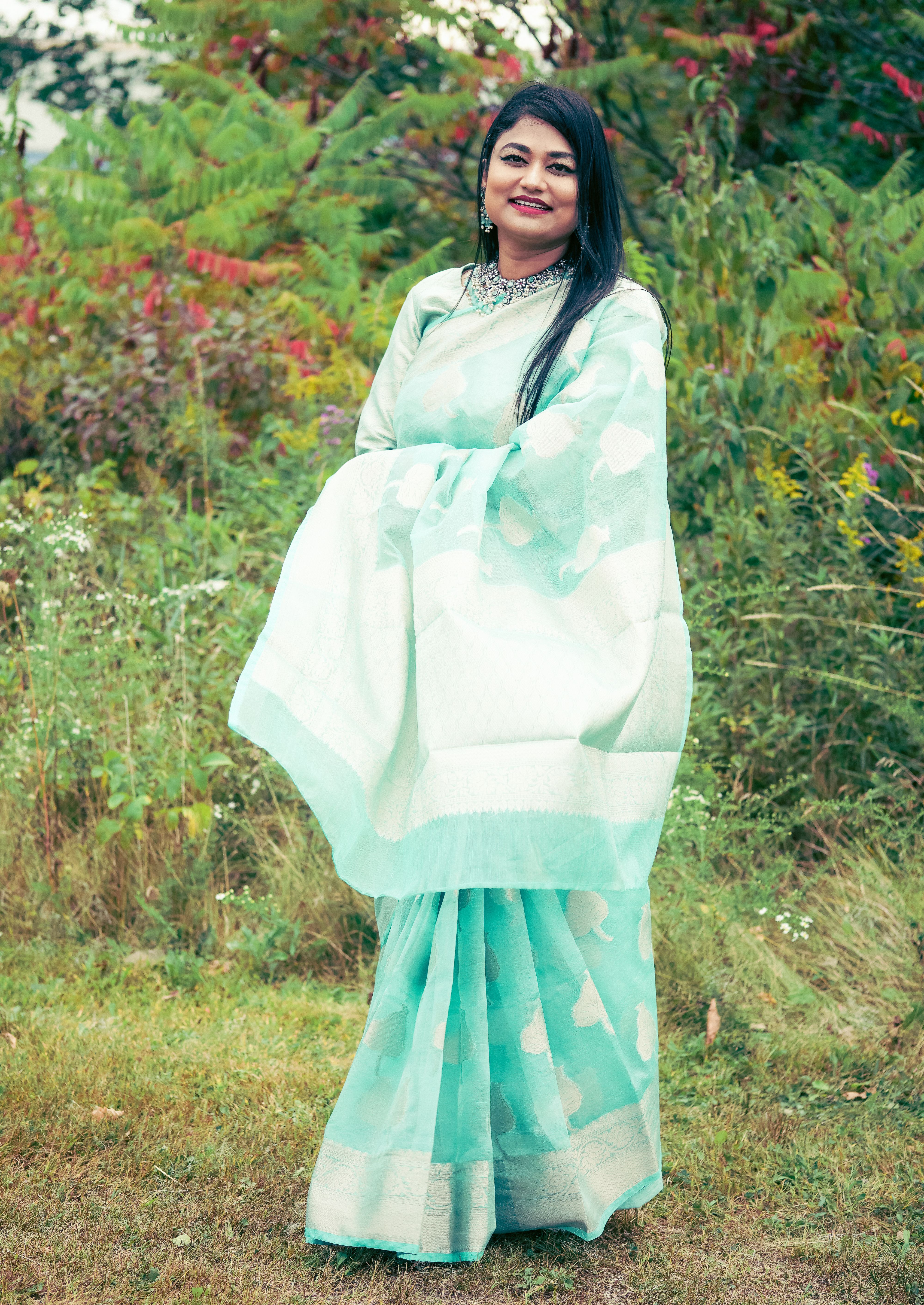 Woman Wearing a Pastel Blue Sari, Posing in a Garden · Free Stock Photo